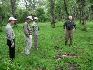 Nichols stands over a chital kill in Nagarahole Park, India with Jim Hines and executive director of TWS Ken Williams. Image courtesy of Jim Nichols. 