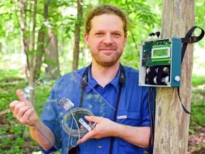 Dan Mennill, the study's senior author, holds a nocturnal flight call microphone used to survey avian biodiversity during migration. ©C. Sanders