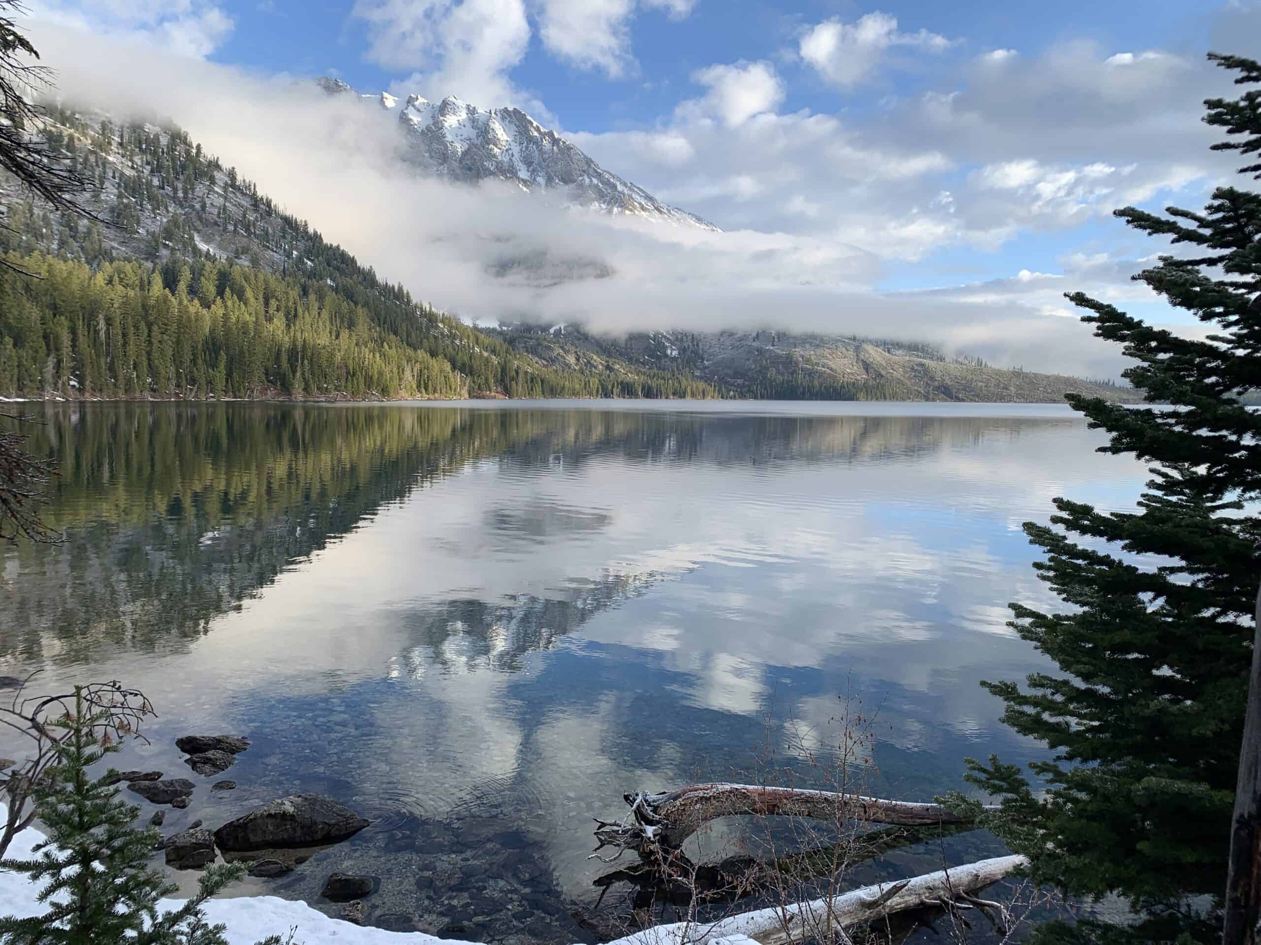 Landscape photo of a lake in front of the Grand Tetons. Credit: _Jonathan Lautenbach