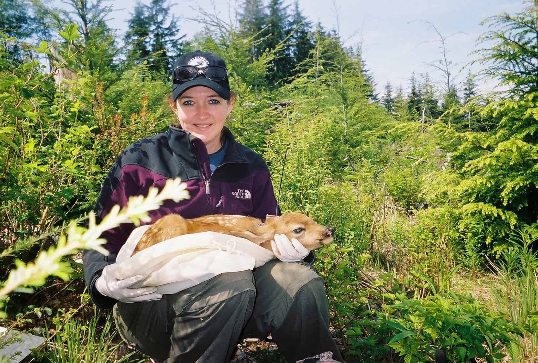 Krysten holds a deer fawn