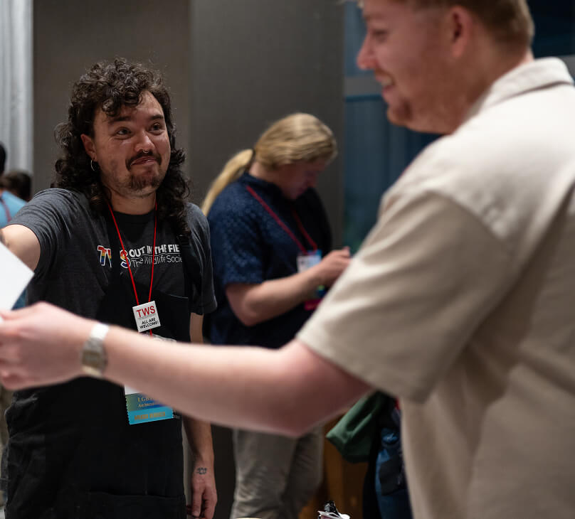 At TWS member welcomes a wildlife professonial into a workshop at The Wildlife Society's annual conference