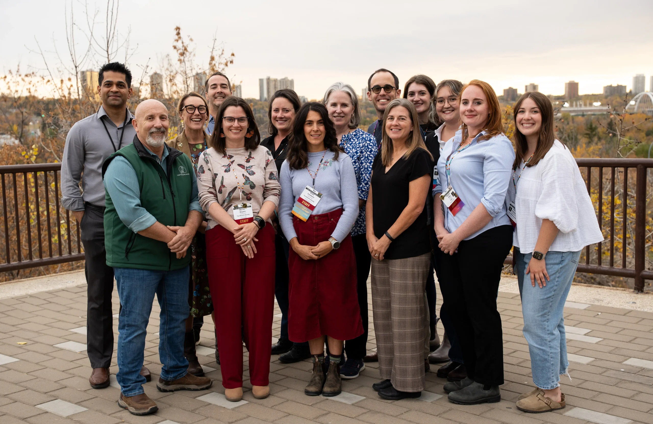 A group of wildlife conservation professionals that make up TWS's council and staff pose in front of pink blooming trees