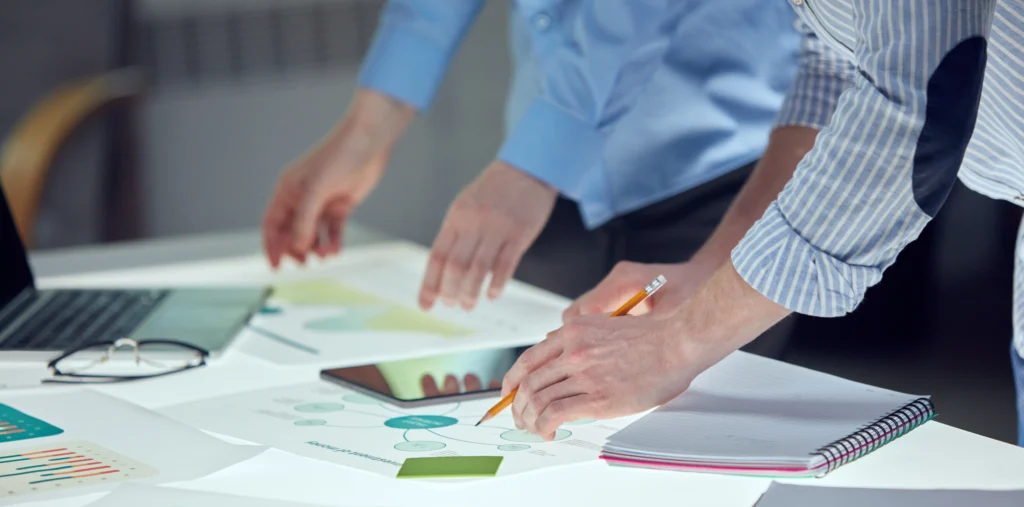 Researchers reviewing data and charts during a scientific peer review process for wildlife conservation and environmental policy studies.