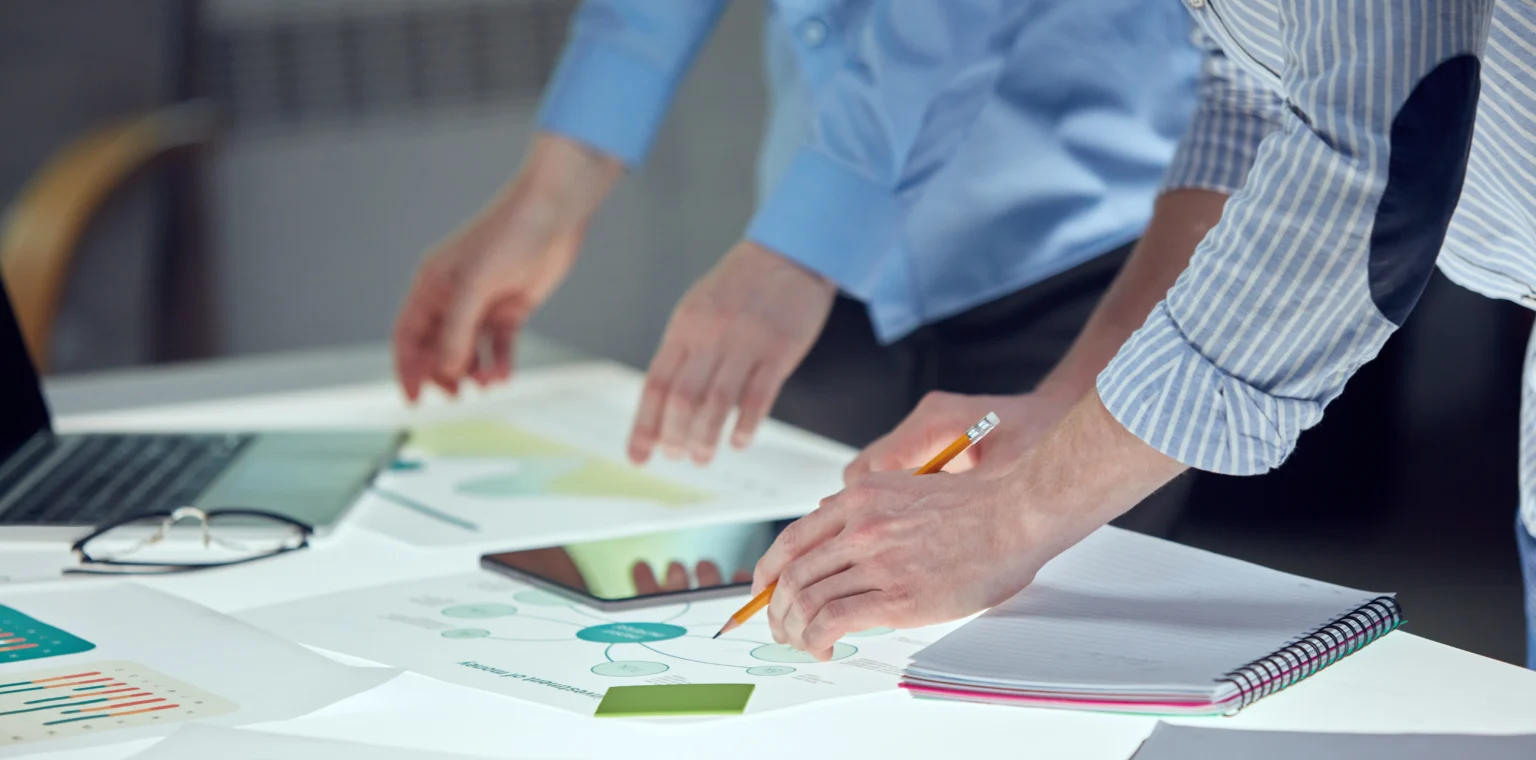 Researchers reviewing data and charts during a scientific peer review process for wildlife conservation and environmental policy studies.