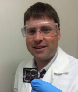 Coauthor Jon Palmer holds a DNA sequence chip. ©Daniel Lindner