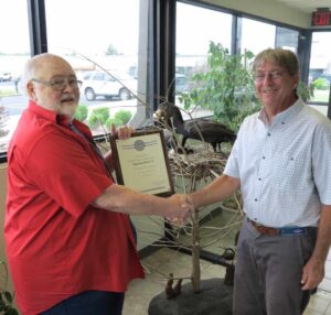 Thurman Booth, CWB and WS-Arkansas state director, receiving plaque and letter from USDA Secretary Vilsack from John McConnell, CWB and WS Eastern Region Assistant State Director. ©USDA Wildlife Services