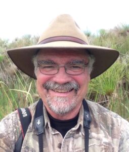 Mark Boyce stands in a papyrus marsh on the Mayanja River in central Uganda, where one of his PhD students is studying antelope. ©Evelyn H. Merrill