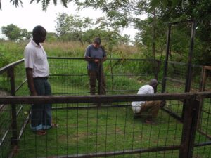 Final touches are placed on the drop door corral trap. 
