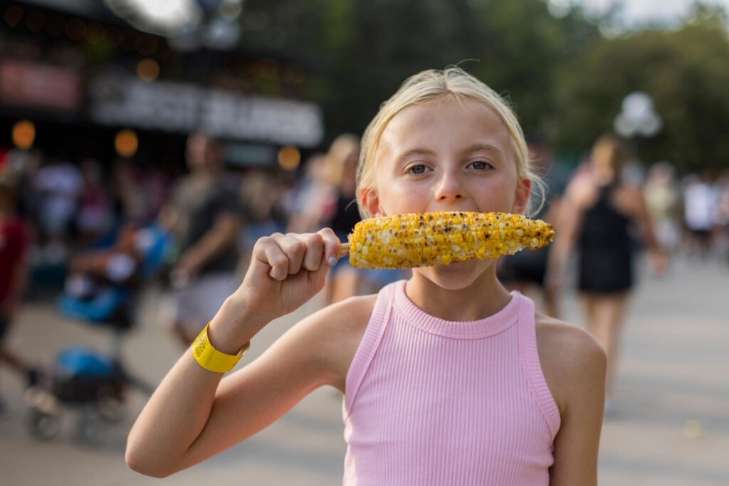 Young girl eating corn on the cob